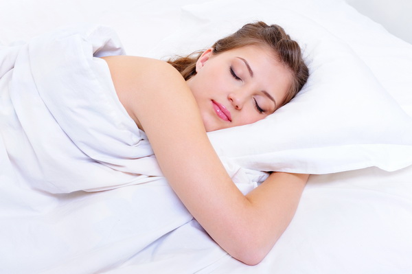 Beautiful young adult woman sleep in her bedroom